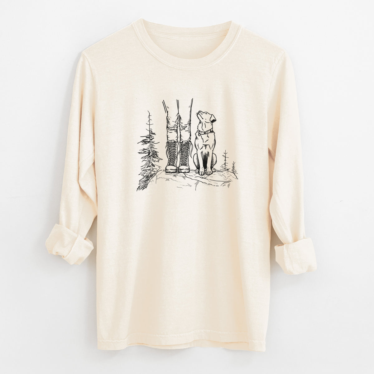 Ivory Comfort Colors long sleeve shirt laid flat with the cuffs rolled, printed with a black ink illustration of a hiker in boots and a dog sitting side by side on a forest trail, seen from behind.