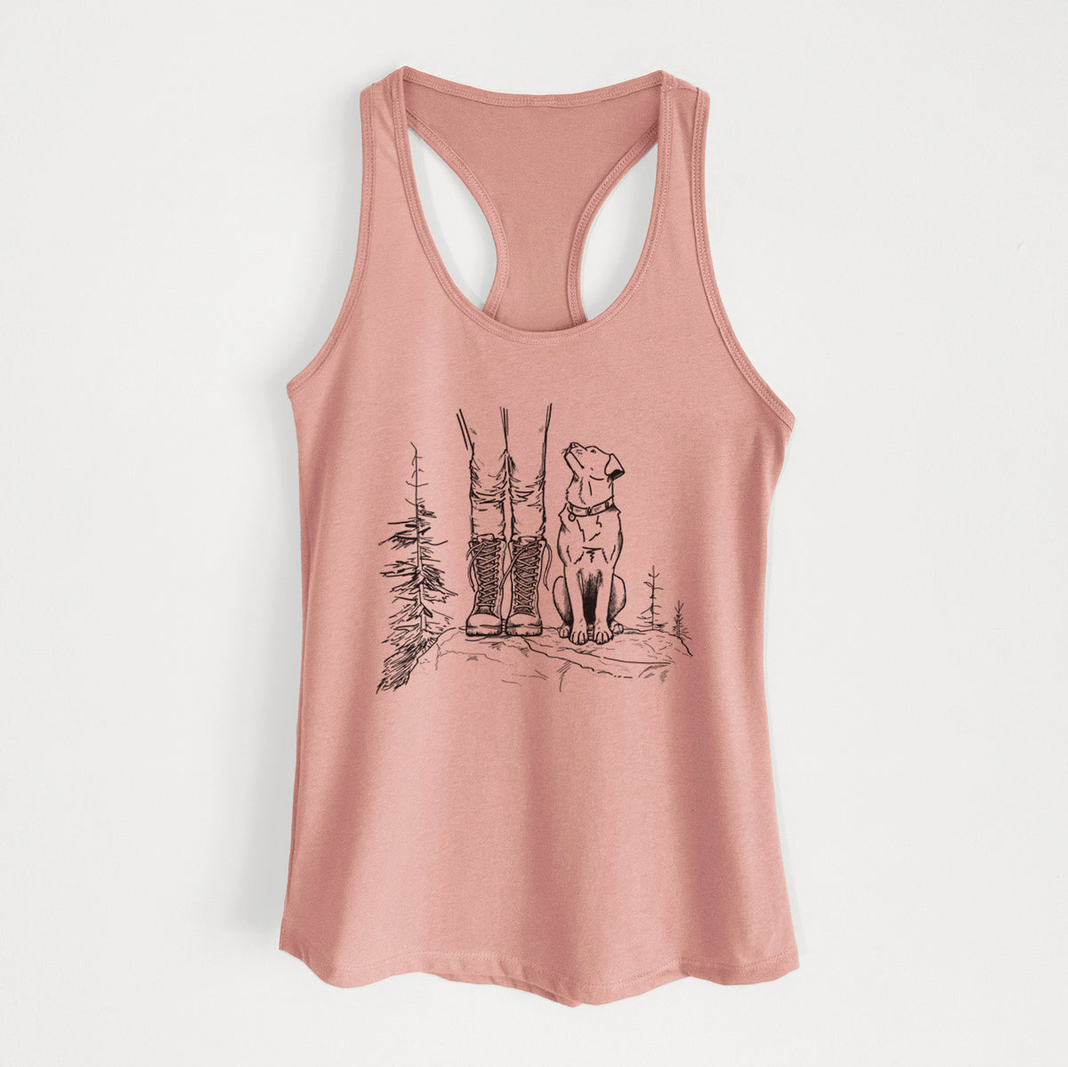 Desert pink women's racerback tank top laid flat, printed with a black ink illustration of a hiker in boots and a dog sitting side by side on a forest trail, seen from behind.