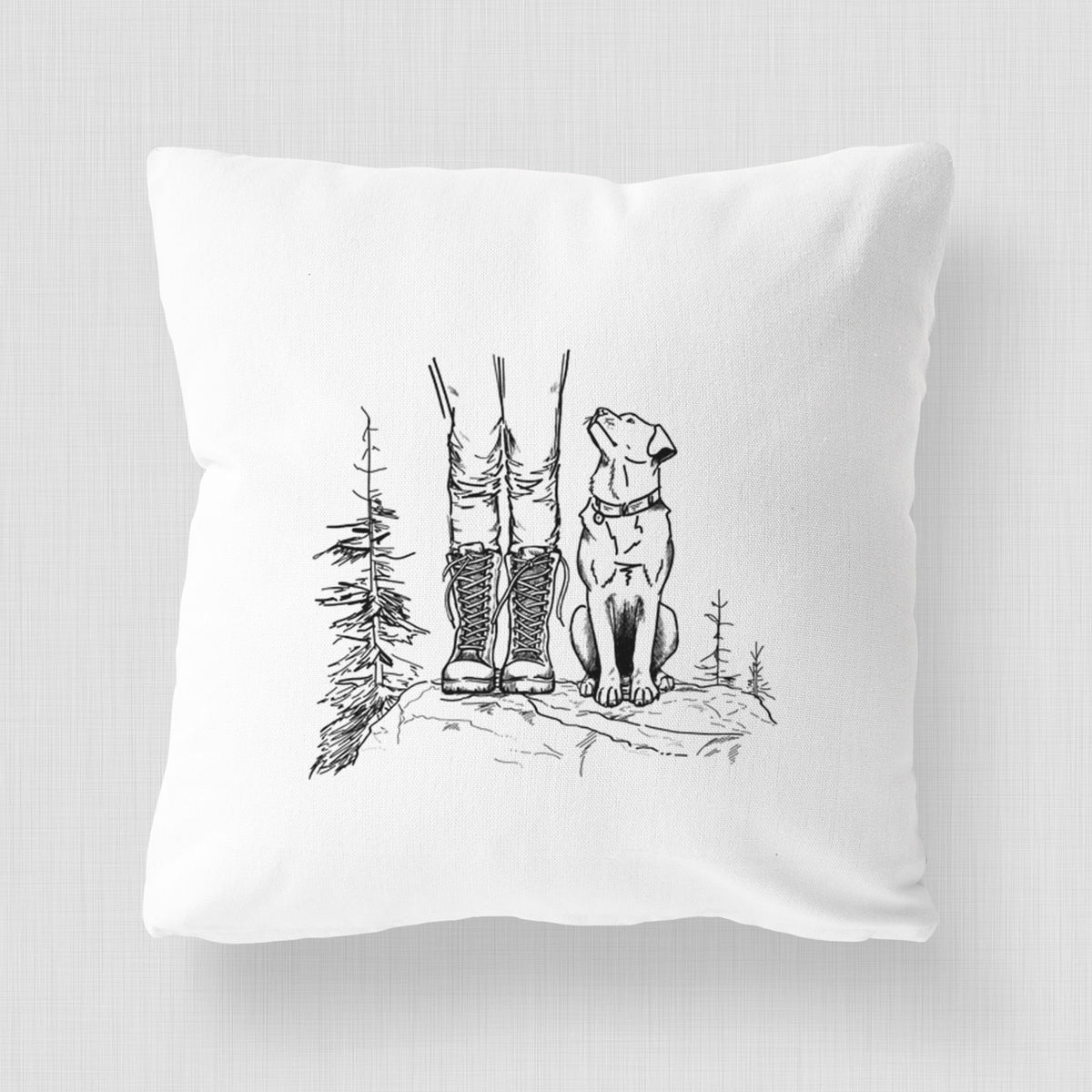 White pillow cover printed with a black ink illustration of a hiker in boots and a dog sitting side by side on a forest trail, seen from behind.