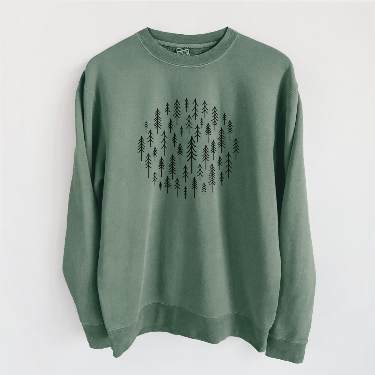 Alpine green pigment dyed crewneck sweatshirt laid flat, printed with a circle made of small black ink pine trees.