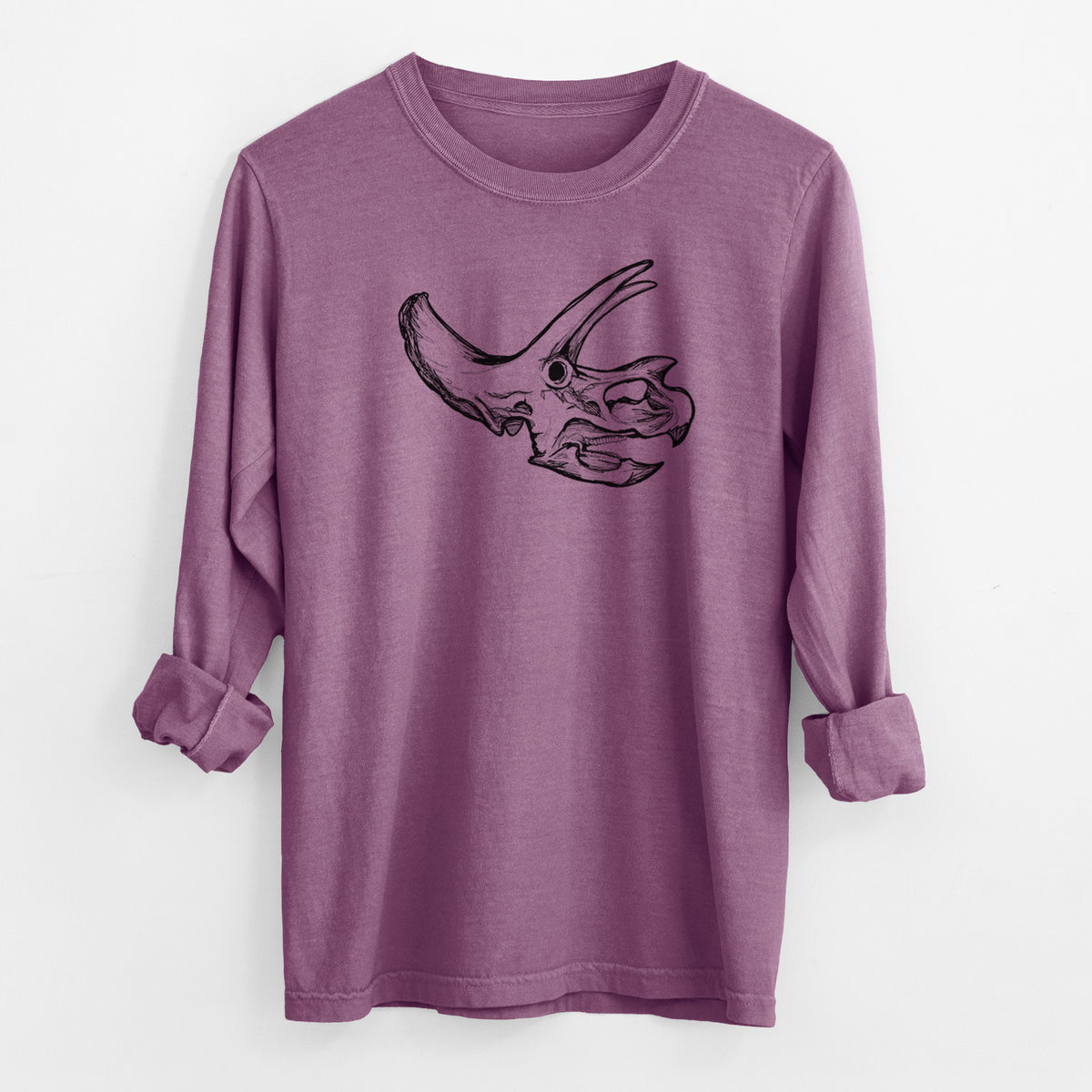 Berry pink Comfort Colors long sleeve shirt laid flat with the cuffs rolled, printed with a detailed black ink illustration of a Triceratops skull with its horns and frill.