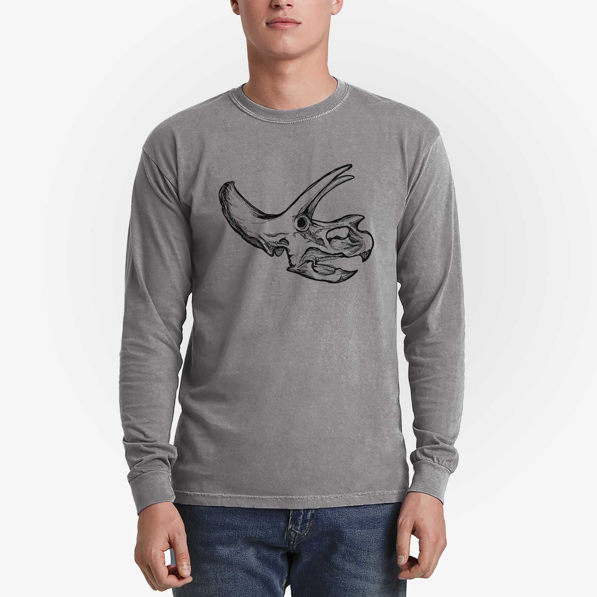 Man wearing a grey Comfort Colors long sleeve shirt printed with a detailed black ink illustration of a Triceratops skull with its horns and frill.