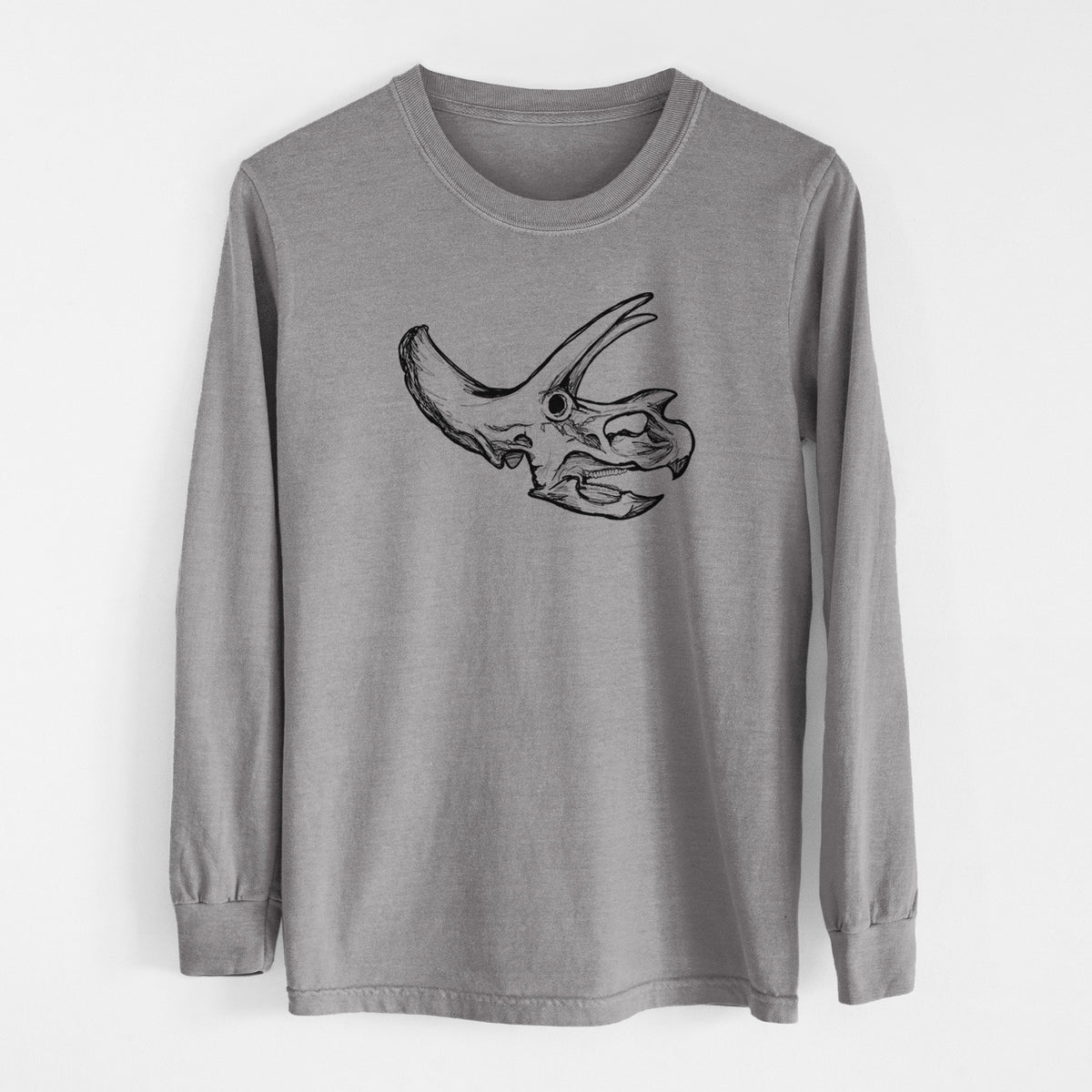 Grey Comfort Colors long sleeve shirt laid flat, printed with a detailed black ink illustration of a Triceratops skull with its horns and frill.