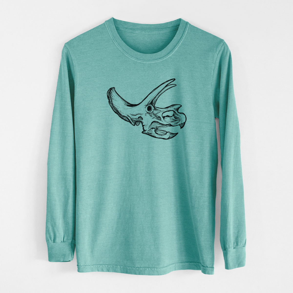 Reef green Comfort Colors long sleeve shirt laid flat, printed with a detailed black ink illustration of a Triceratops skull with its horns and frill.