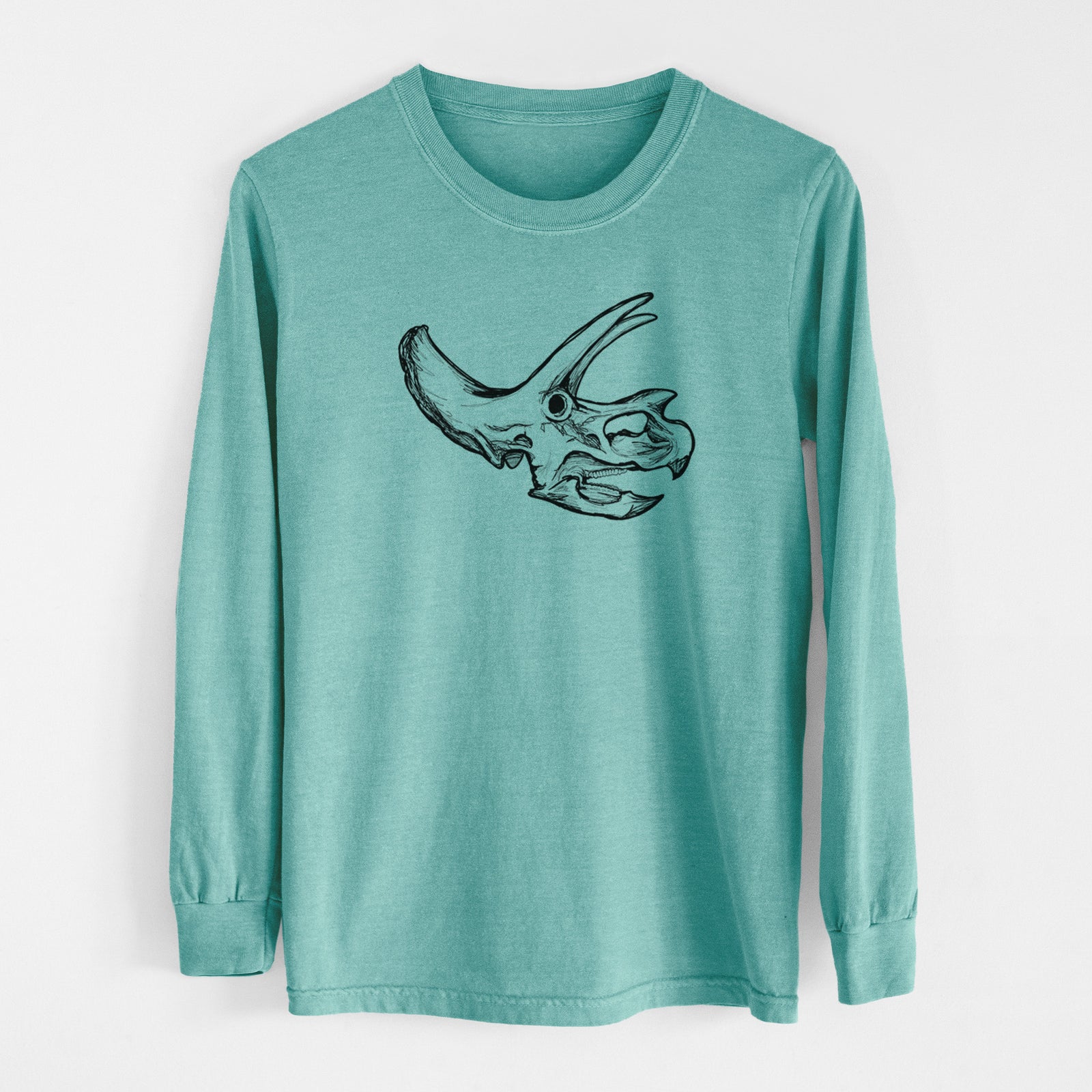 Reef green Comfort Colors long sleeve shirt laid flat, printed with a detailed black ink illustration of a Triceratops skull with its horns and frill.
