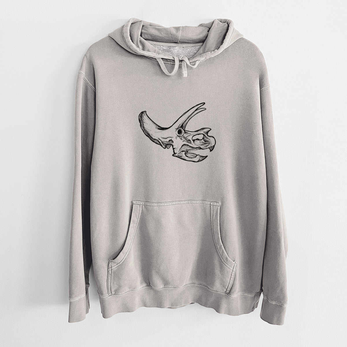 Cement grey pigment dyed hoodie laid flat, printed with a detailed black ink illustration of a Triceratops skull with its horns and frill.