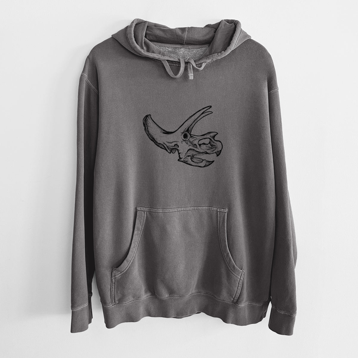 Faded black pigment dyed hoodie laid flat, printed with a detailed black ink illustration of a Triceratops skull with its horns and frill.