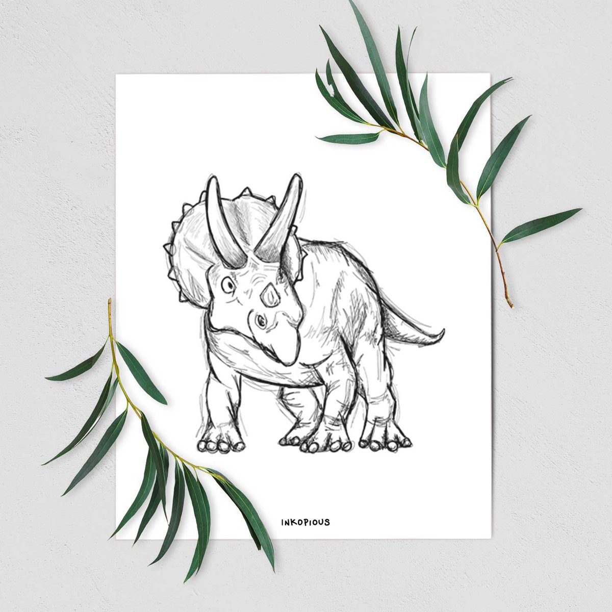 Art print of a black ink illustration of a Triceratops walking, shown with eucalyptus leaves.
