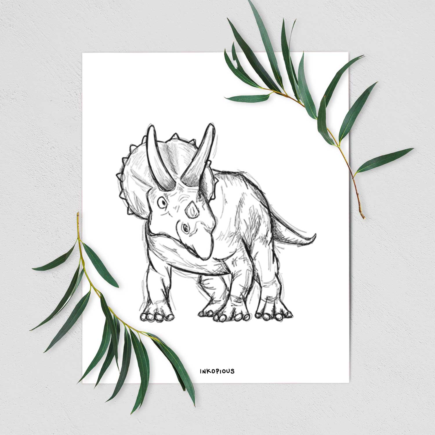 Art print of a black ink illustration of a Triceratops walking, shown with eucalyptus leaves.