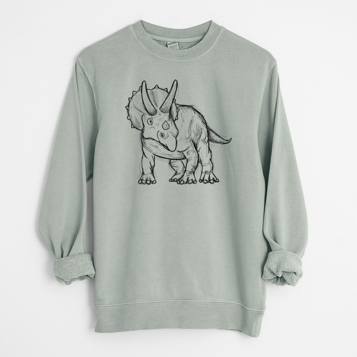 Sage green pigment dyed crewneck sweatshirt laid flat with the sleeves rolled, printed with a black ink illustration of a Triceratops walking.