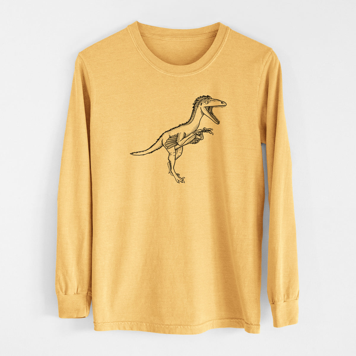 Golden wheat yellow Comfort Colors long sleeve shirt laid flat, printed with a black ink illustration of a Troodon dinosaur running.