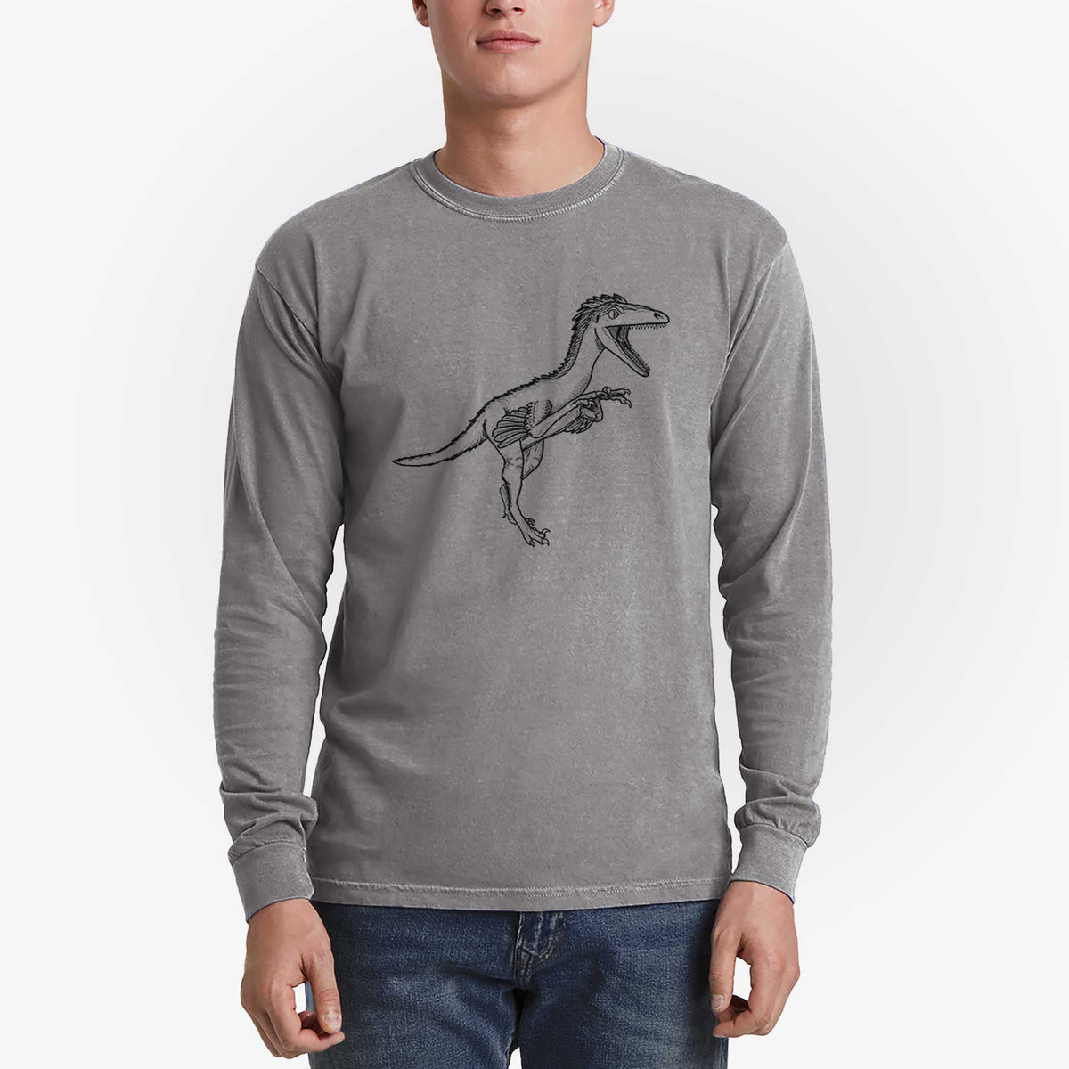 Man wearing a grey Comfort Colors long sleeve shirt printed with a black ink illustration of a Troodon dinosaur running.