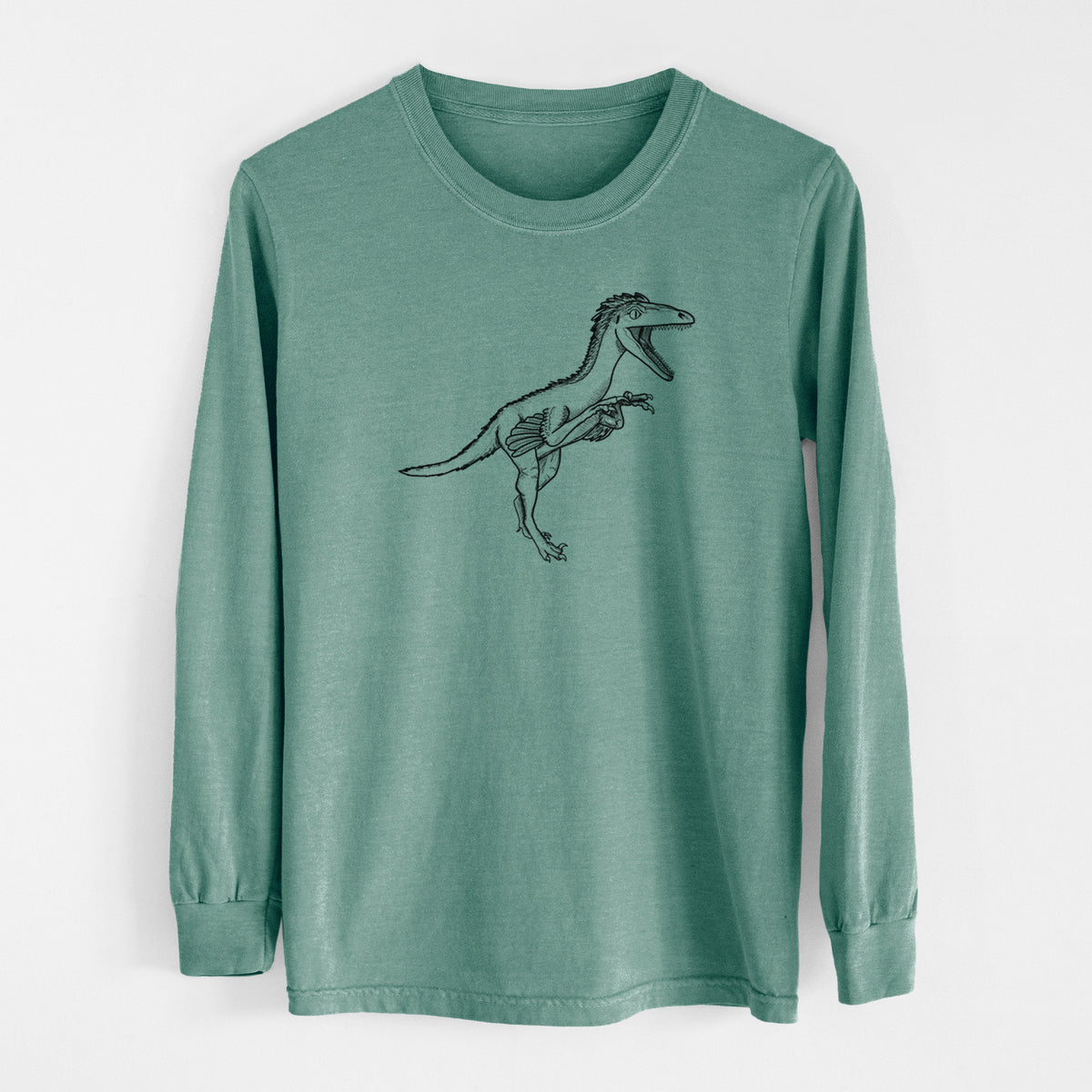 Pine green Comfort Colors long sleeve shirt laid flat, printed with a black ink illustration of a Troodon dinosaur running.