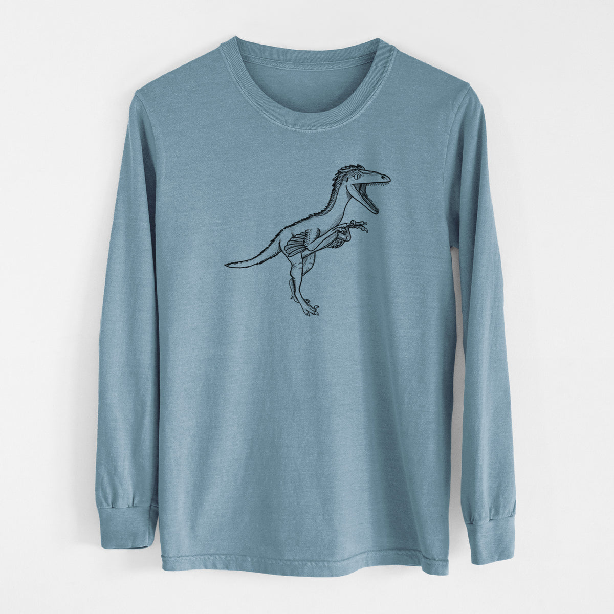Steel blue Comfort Colors long sleeve shirt laid flat, printed with a black ink illustration of a Troodon dinosaur running.