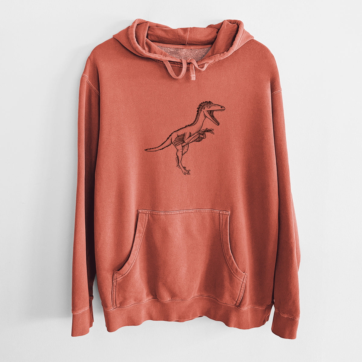 Amber orange pigment dyed hoodie laid flat, printed with a black ink illustration of a Troodon dinosaur running.