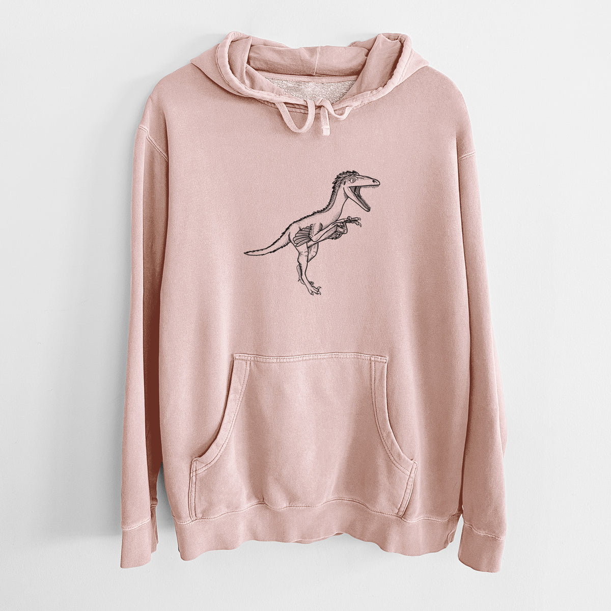 Dusty pink pigment dyed hoodie laid flat, printed with a black ink illustration of a Troodon dinosaur running.