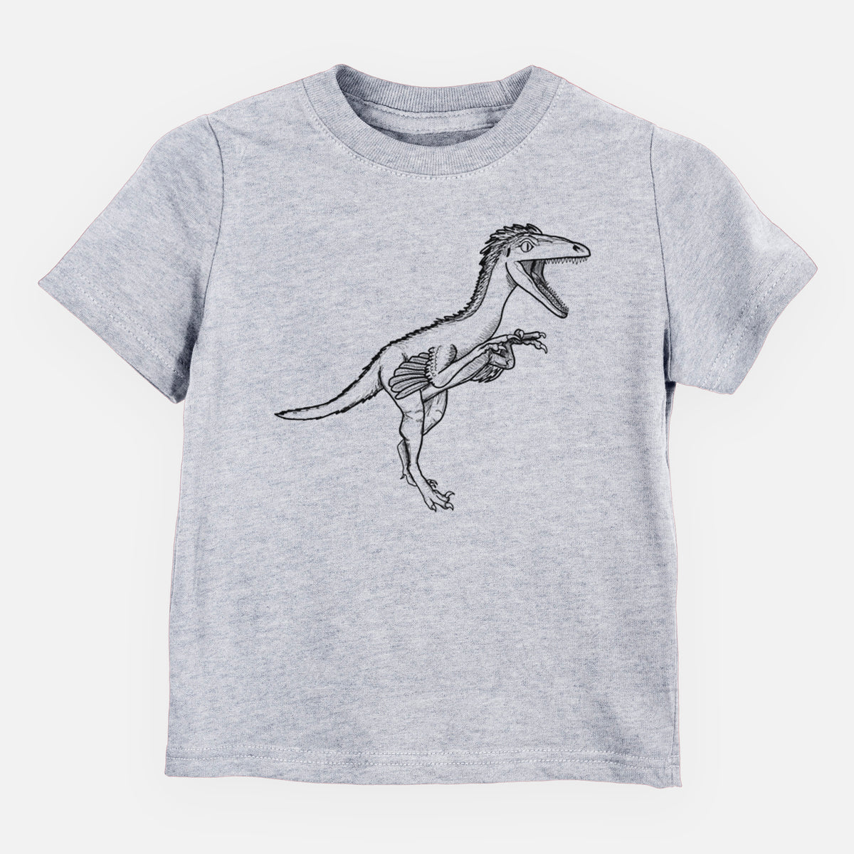 Heather grey toddler t-shirt laid flat, printed with a black ink illustration of a Troodon dinosaur running.