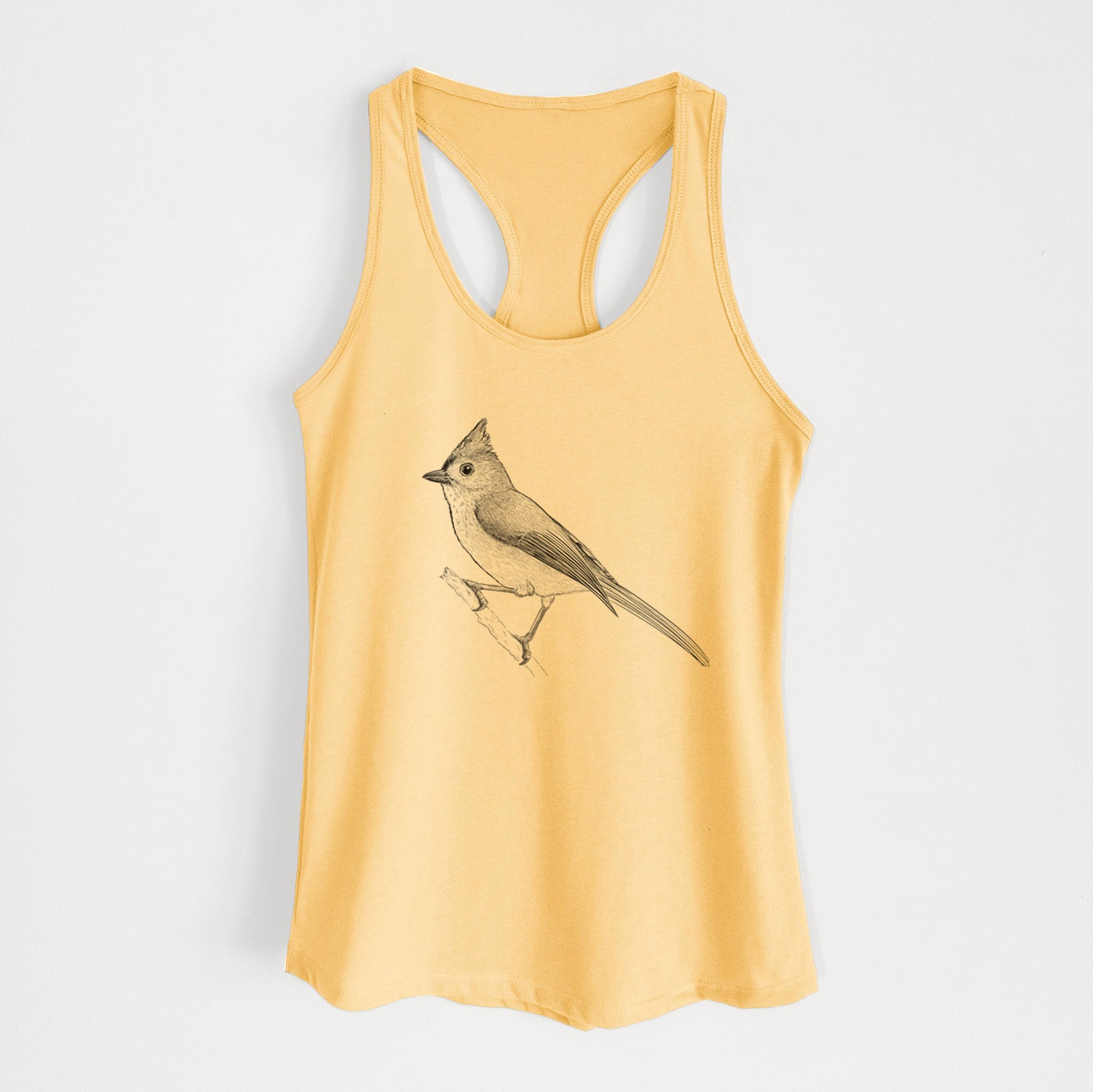 Banana cream women's racerback tank top laid flat, printed with a detailed black ink sketch of a tufted titmouse perched on a branch.