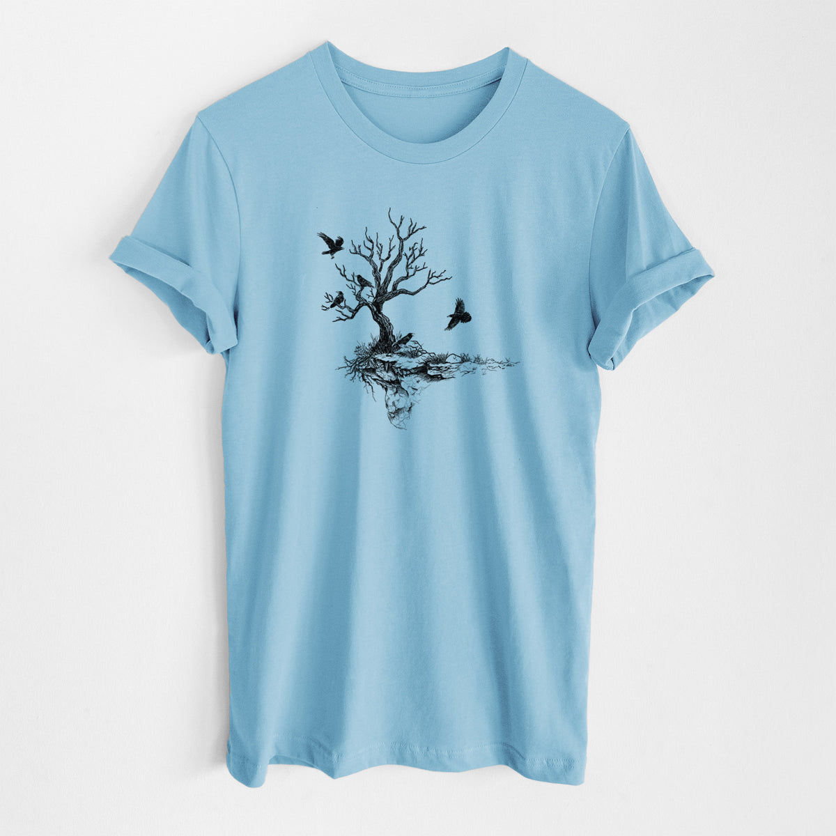 Ocean blue lightweight cotton t-shirt laid flat, printed with a black ink illustration of a bare twisted tree on a small island with ravens flying around it.