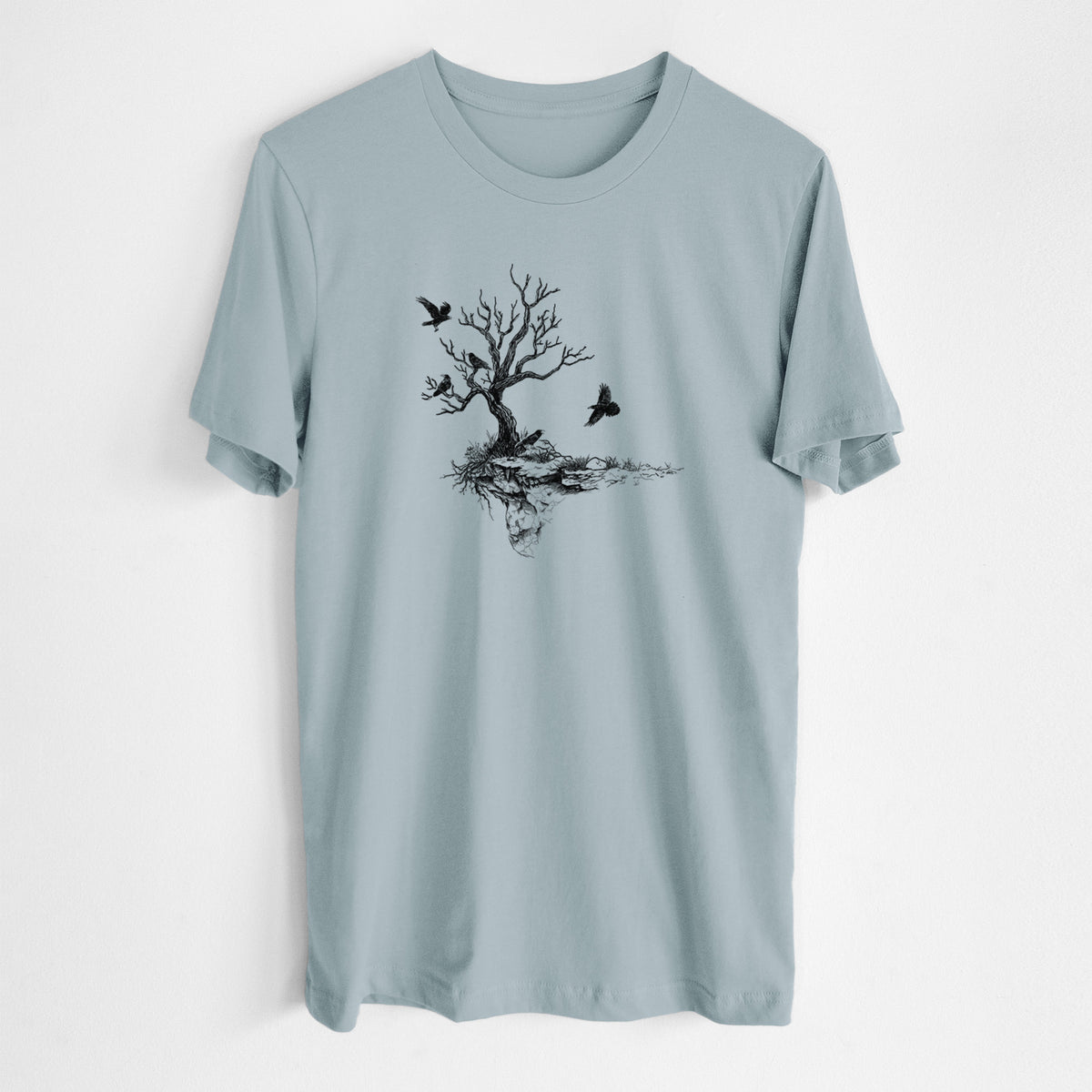 Vintage denim lightweight cotton t-shirt laid flat, printed with a black ink illustration of a bare twisted tree on a small island with ravens flying around it.