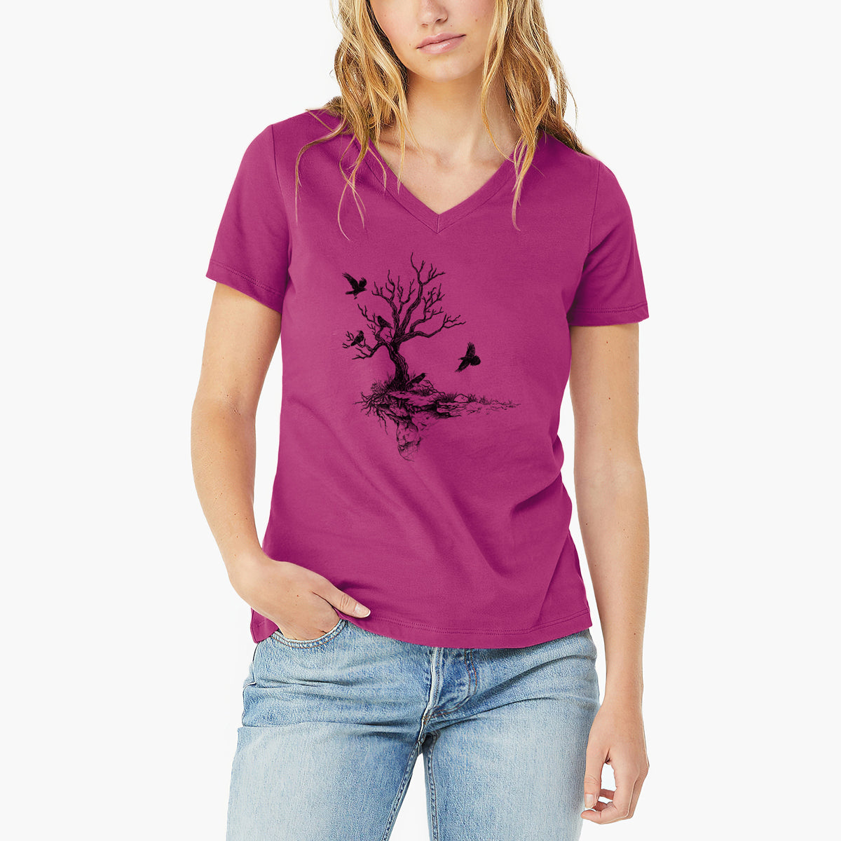 Woman wearing a berry pink women's relaxed fit cotton V-neck t-shirt printed with a black ink illustration of a bare twisted tree on a small island with ravens flying around it.