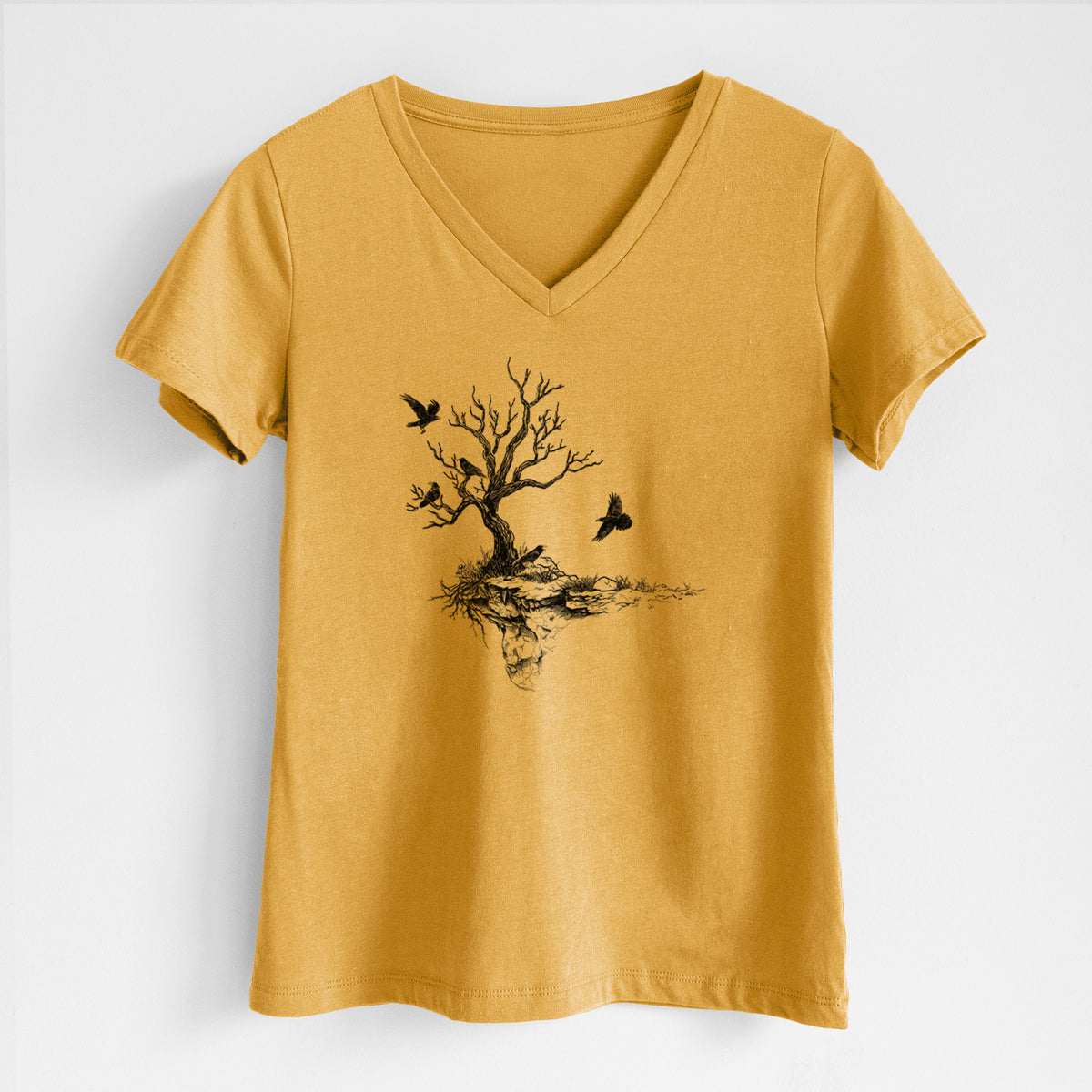 Honeycomb yellow women's relaxed fit cotton V-neck t-shirt laid flat, printed with a black ink illustration of a bare twisted tree on a small island with ravens flying around it.