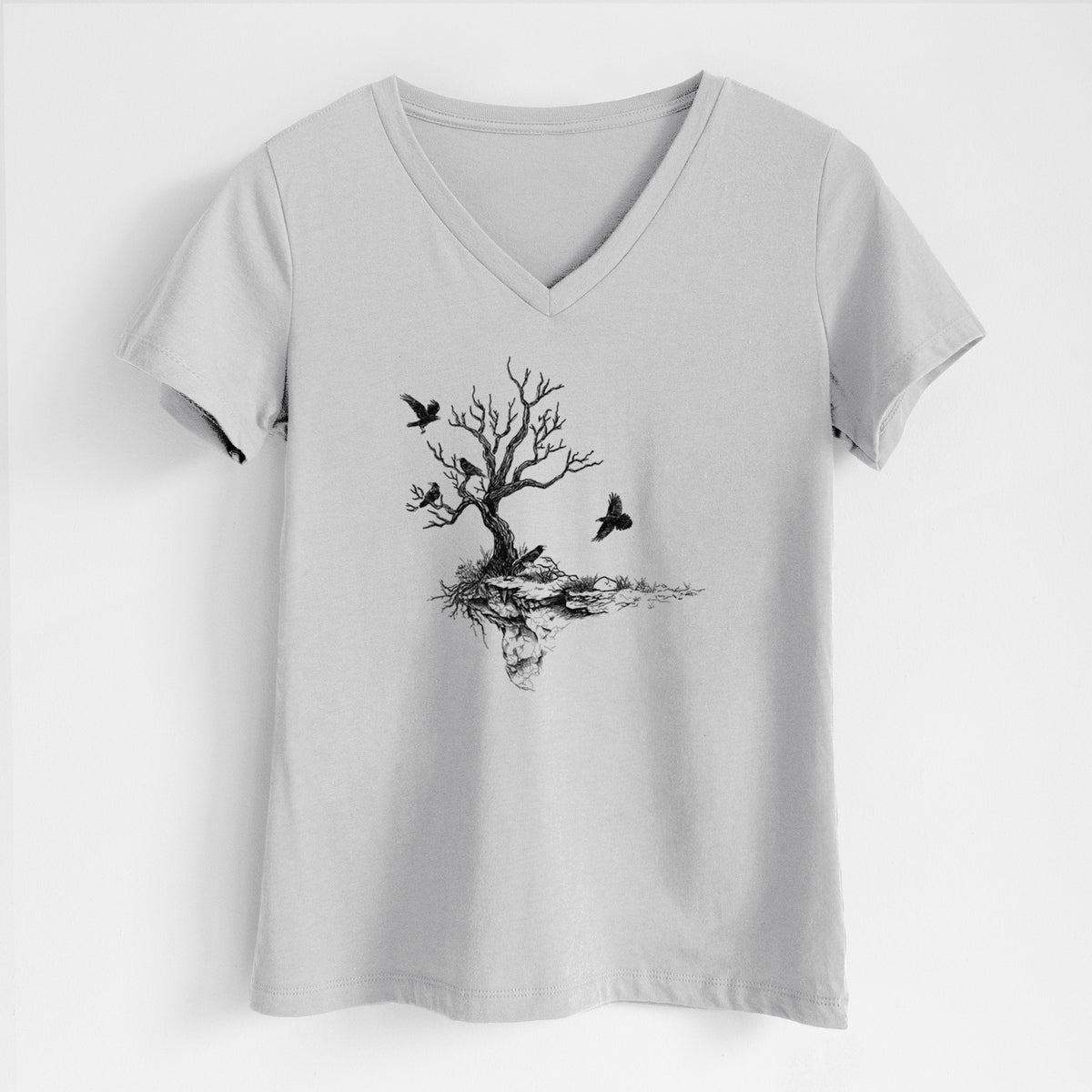 Lunar grey women's relaxed fit cotton V-neck t-shirt laid flat, printed with a black ink illustration of a bare twisted tree on a small island with ravens flying around it.