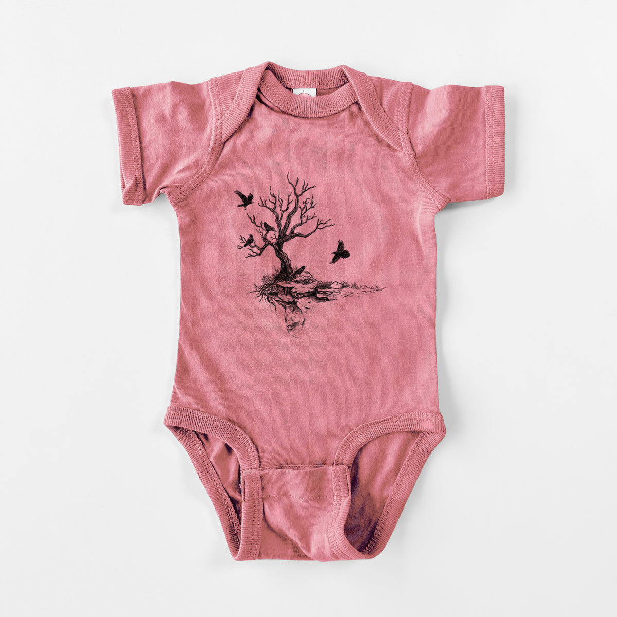 Mauve pink baby bodysuit laid flat, printed with a black ink illustration of a bare twisted tree on a small island with ravens flying around it.