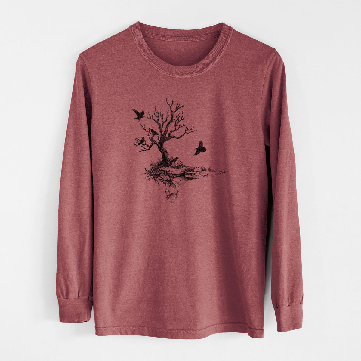 Brick red Comfort Colors long sleeve shirt laid flat, printed with a black ink illustration of a bare twisted tree on a small island with ravens flying around it.