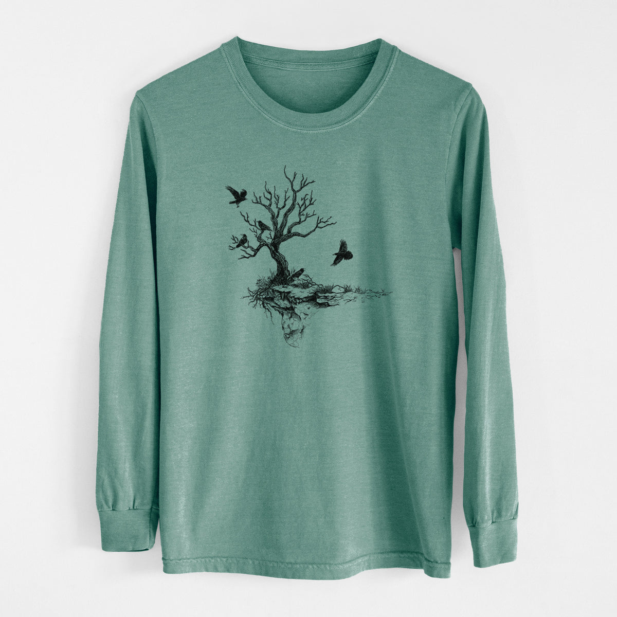 Pine green Comfort Colors long sleeve shirt laid flat, printed with a black ink illustration of a bare twisted tree on a small island with ravens flying around it.