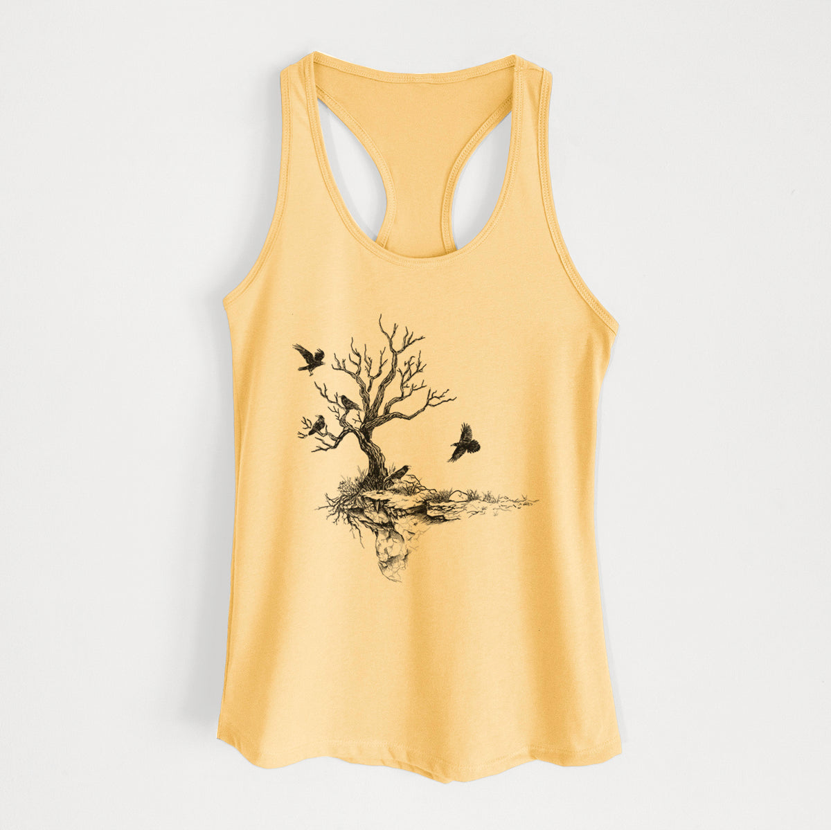 Banana cream women's racerback tank top laid flat, printed with a black ink illustration of a bare twisted tree on a small island with ravens flying around it.