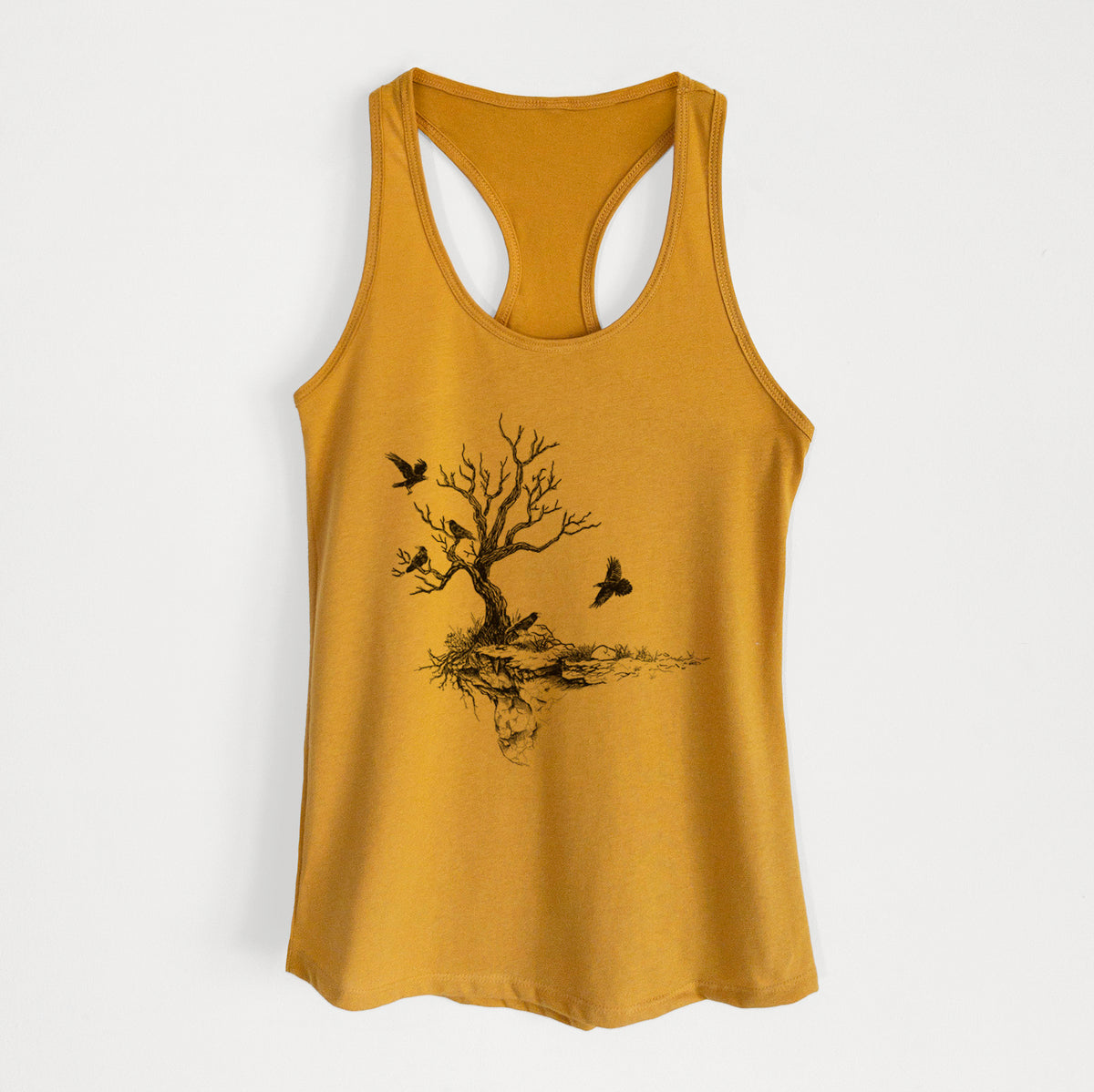 Gold women's racerback tank top laid flat, printed with a black ink illustration of a bare twisted tree on a small island with ravens flying around it.
