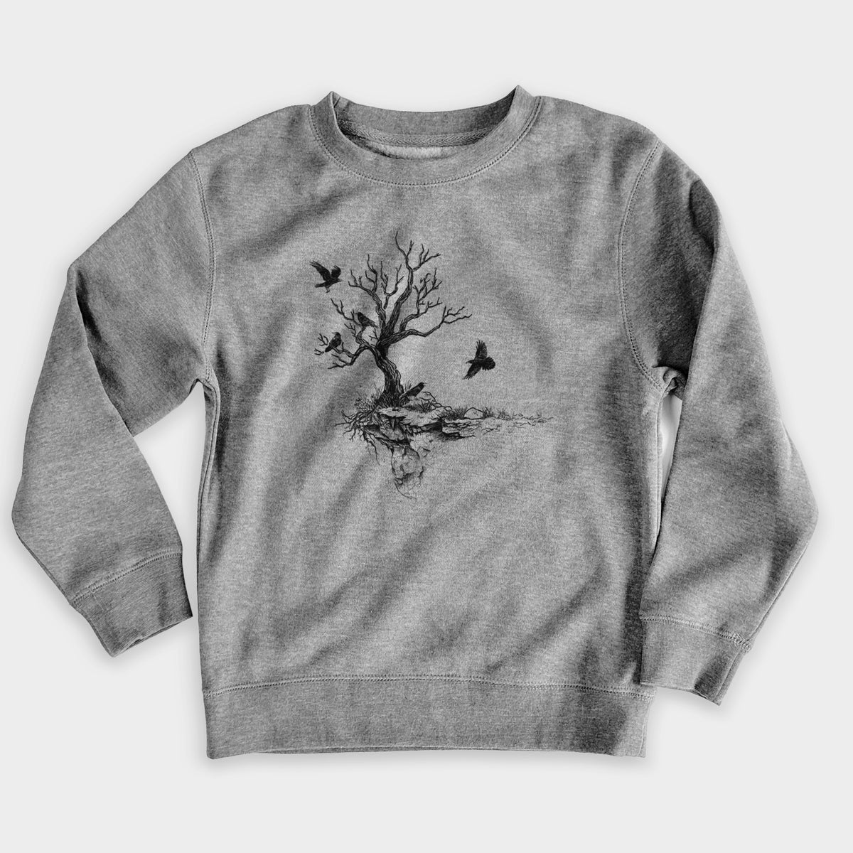 Nickel grey youth crewneck sweatshirt laid flat, printed with a black ink illustration of a bare twisted tree on a small island with ravens flying around it.