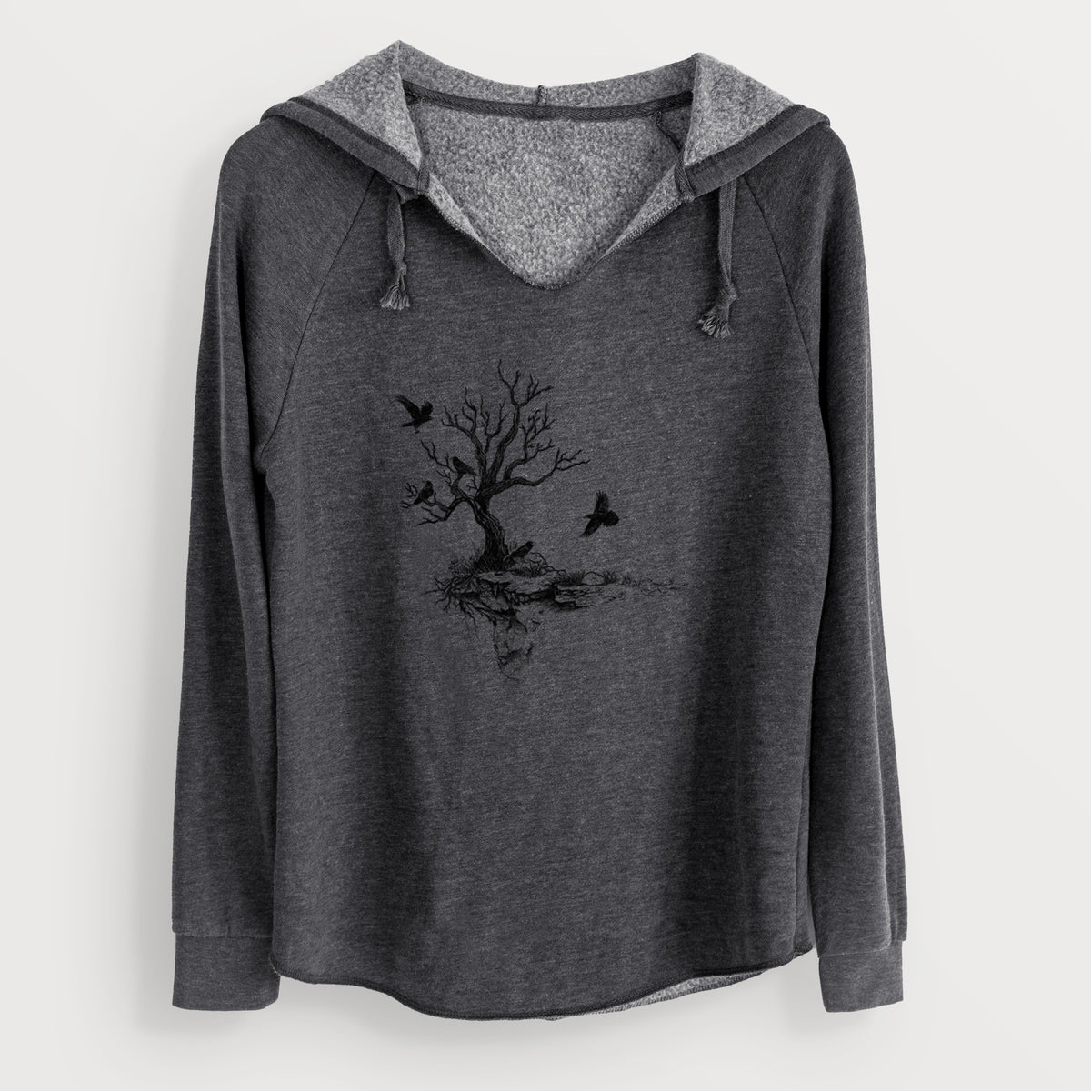 Charcoal grey women's Cali Wave hooded sweatshirt laid flat, printed with a black ink illustration of a bare twisted tree on a small island with ravens flying around it.