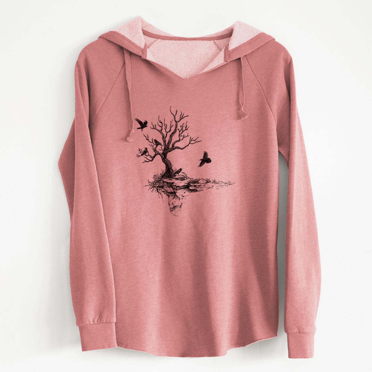 Dusty rose women's Cali Wave hooded sweatshirt laid flat, printed with a black ink illustration of a bare twisted tree on a small island with ravens flying around it.