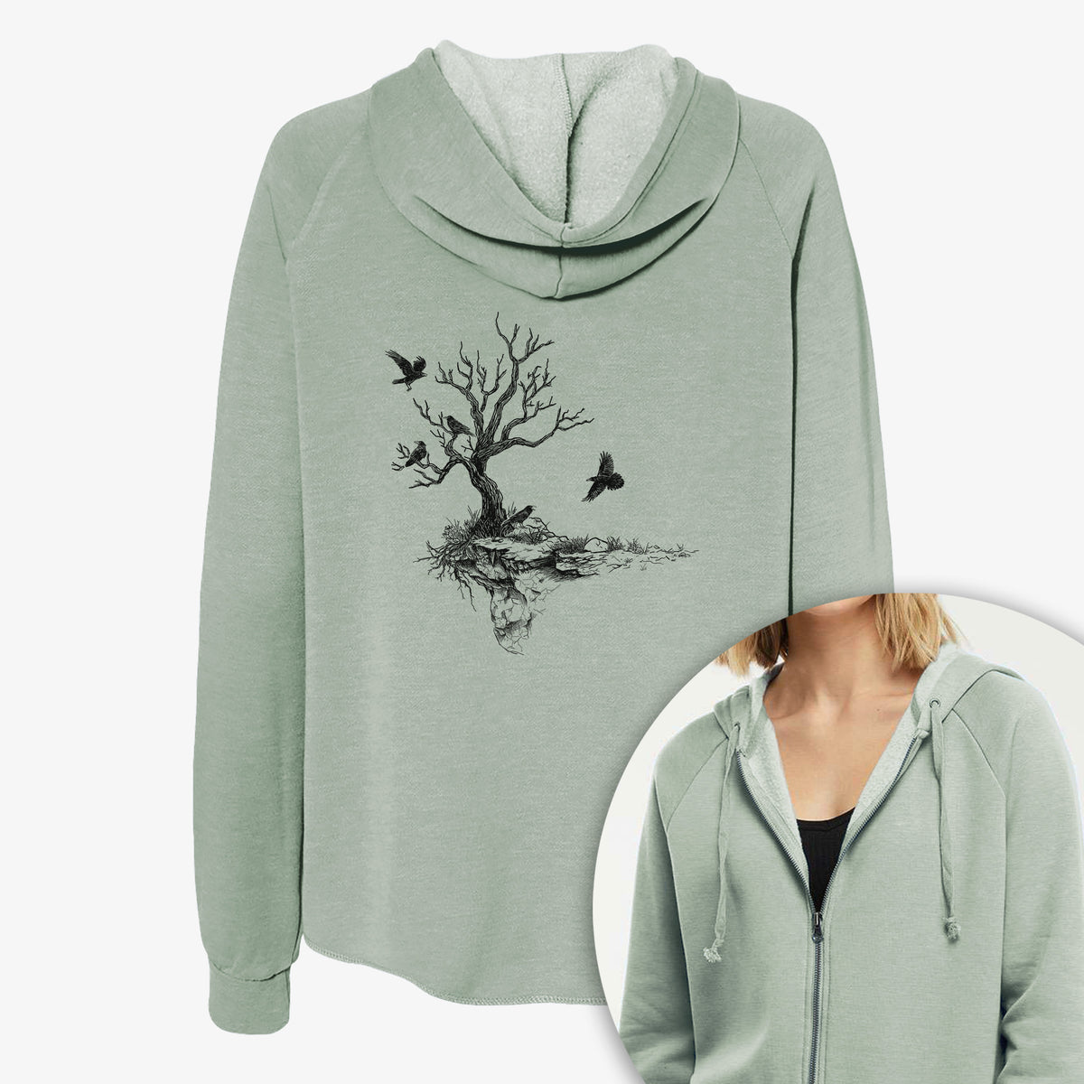 Women's Cali Wave zip-up sweatshirt printed with a black ink illustration of a bare twisted tree on a small island with ravens flying around it, with a close-up of the zipper.