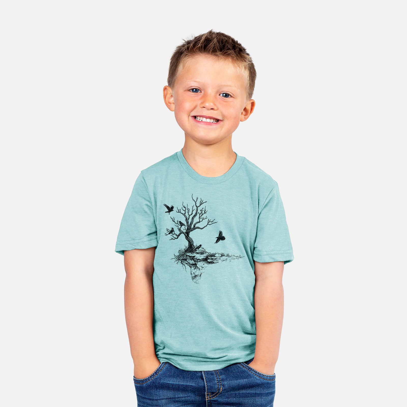 Two youth t-shirts in different colors on hangers, printed with a black ink illustration of a bare twisted tree on a small island with ravens flying around it.