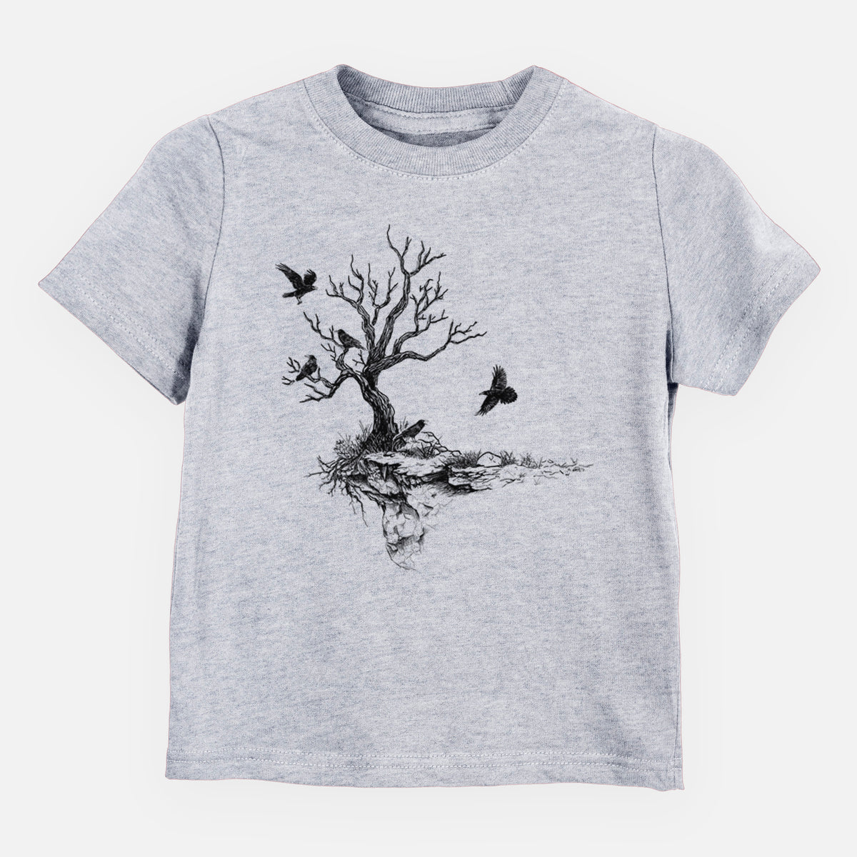 Heather grey toddler t-shirt laid flat, printed with a black ink illustration of a bare twisted tree on a small island with ravens flying around it.
