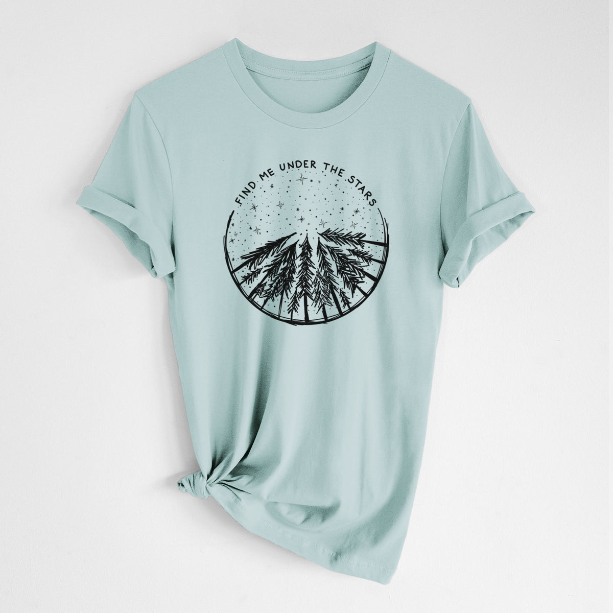 Dusty blue lightweight cotton t-shirt laid flat with the sleeves rolled, printed with a circle of pine trees under a starry sky, with the words Find Me Under the Stars.