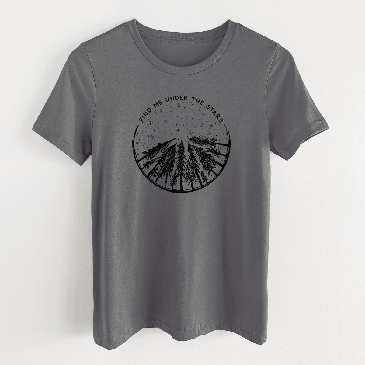 Asphalt women's relaxed fit cotton t-shirt laid flat, printed with a circle of pine trees under a starry sky, with the words Find Me Under the Stars.