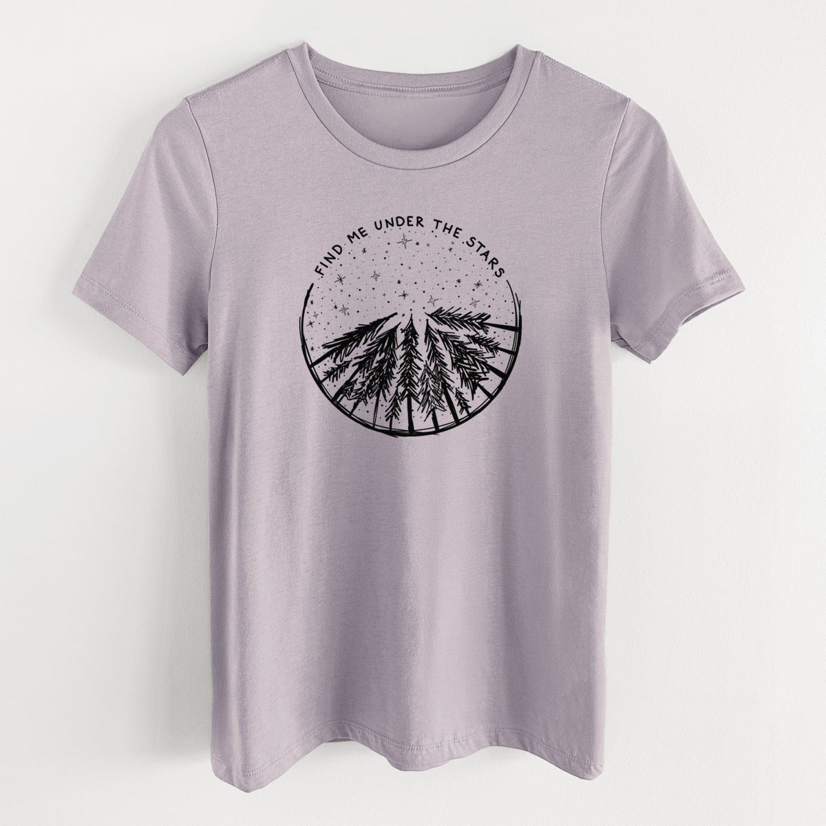Light violet women's relaxed fit cotton t-shirt laid flat, printed with a circle of pine trees under a starry sky, with the words Find Me Under the Stars.