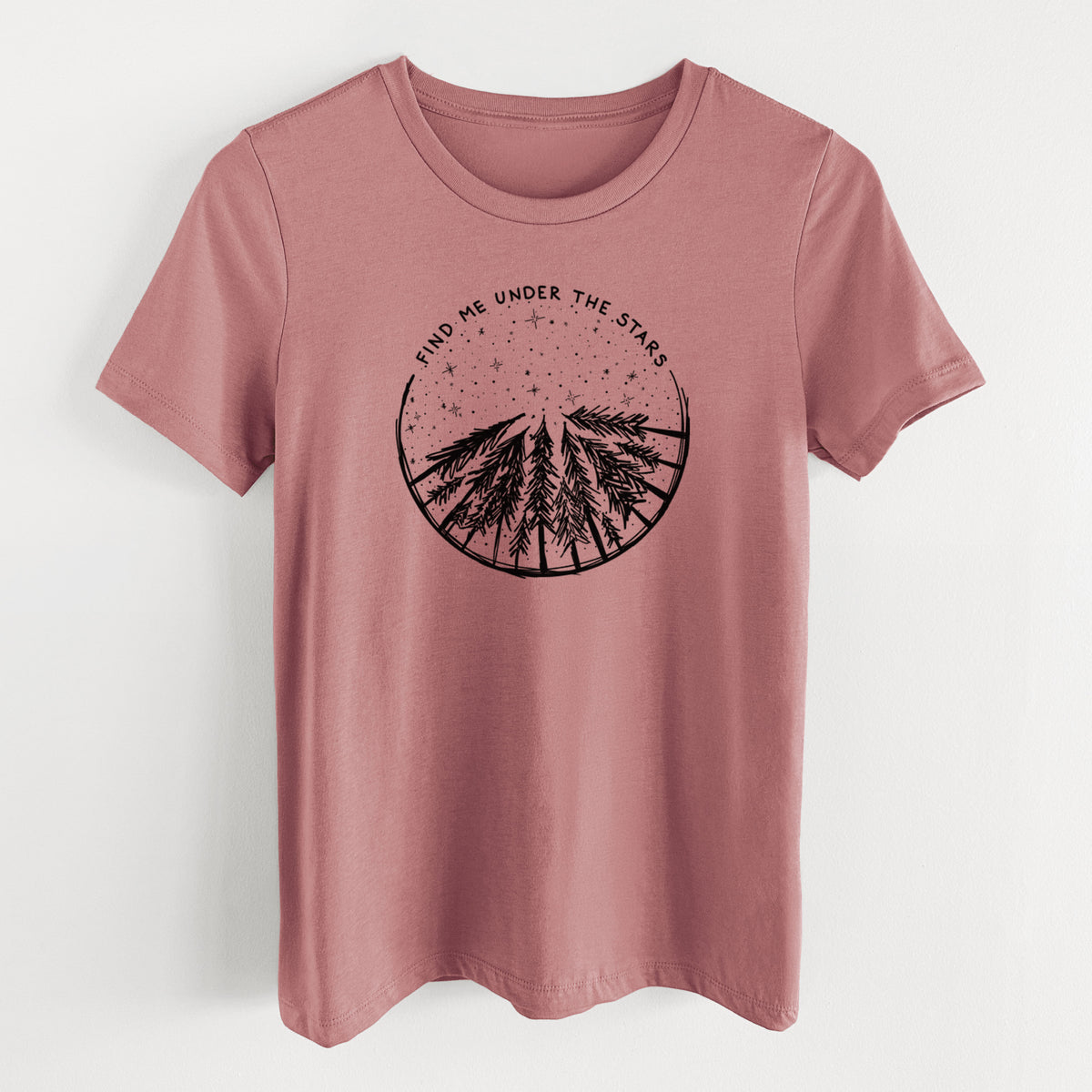 Mauve pink women's relaxed fit cotton t-shirt laid flat, printed with a circle of pine trees under a starry sky, with the words Find Me Under the Stars.
