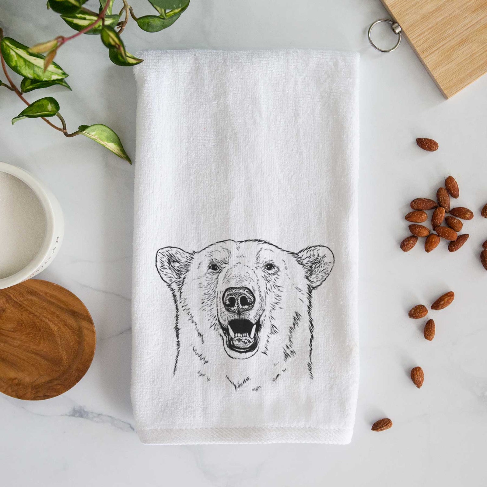 White hand towel printed with a black ink portrait of a smiling polar bear's face.