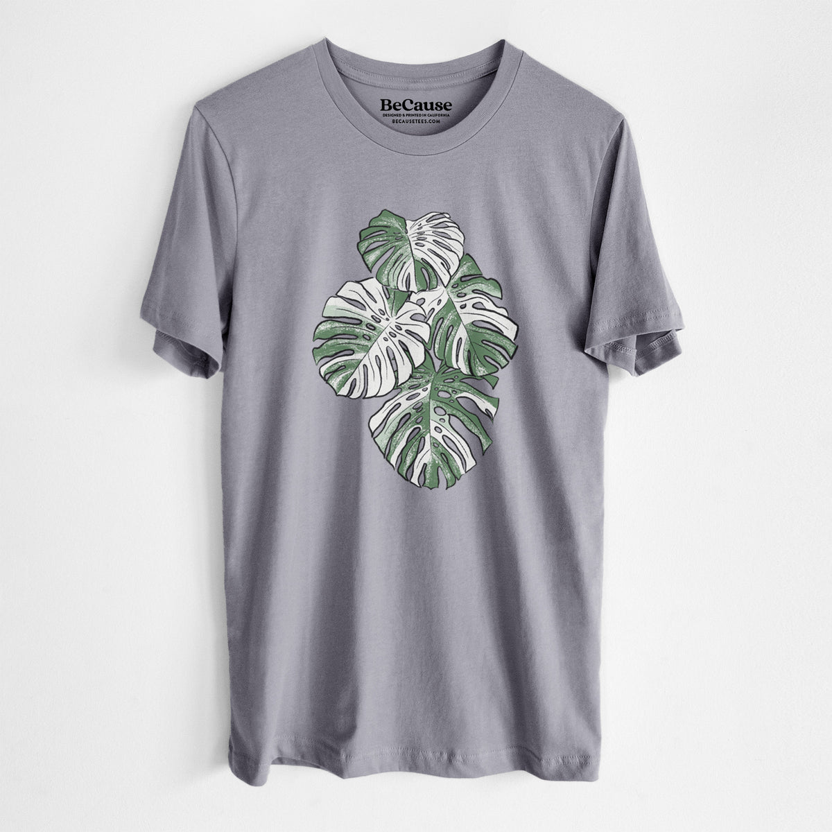 Storm grey lightweight cotton t-shirt laid flat, printed with a full-color illustration of a variegated Monstera leaf in green and white.