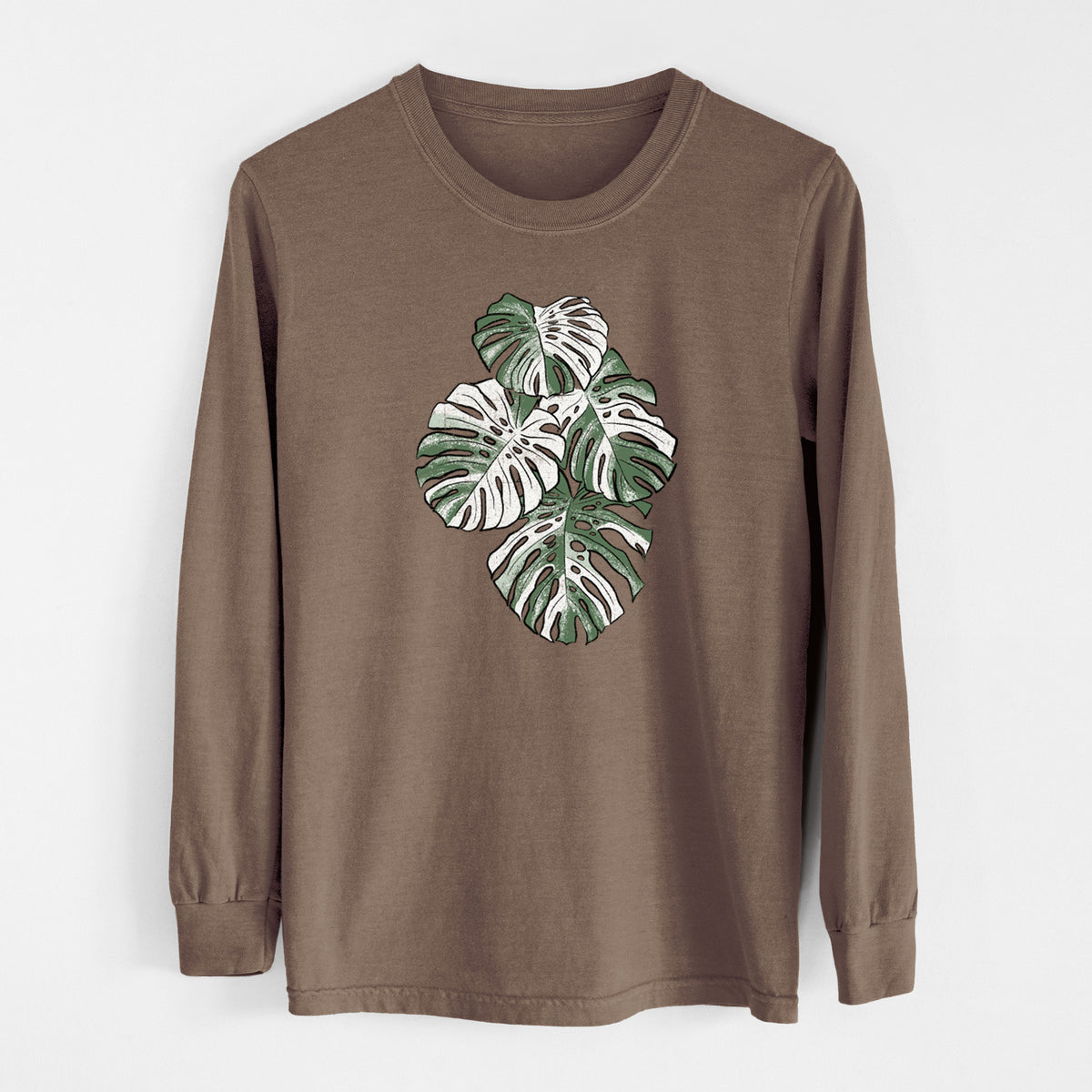 Espresso brown Comfort Colors long sleeve shirt laid flat, printed with a full-color illustration of a variegated Monstera leaf in green and white.