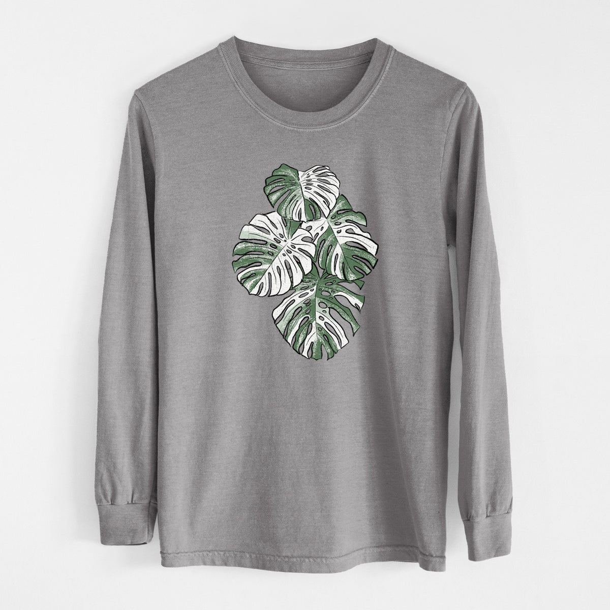 Grey Comfort Colors long sleeve shirt laid flat, printed with a full-color illustration of a variegated Monstera leaf in green and white.