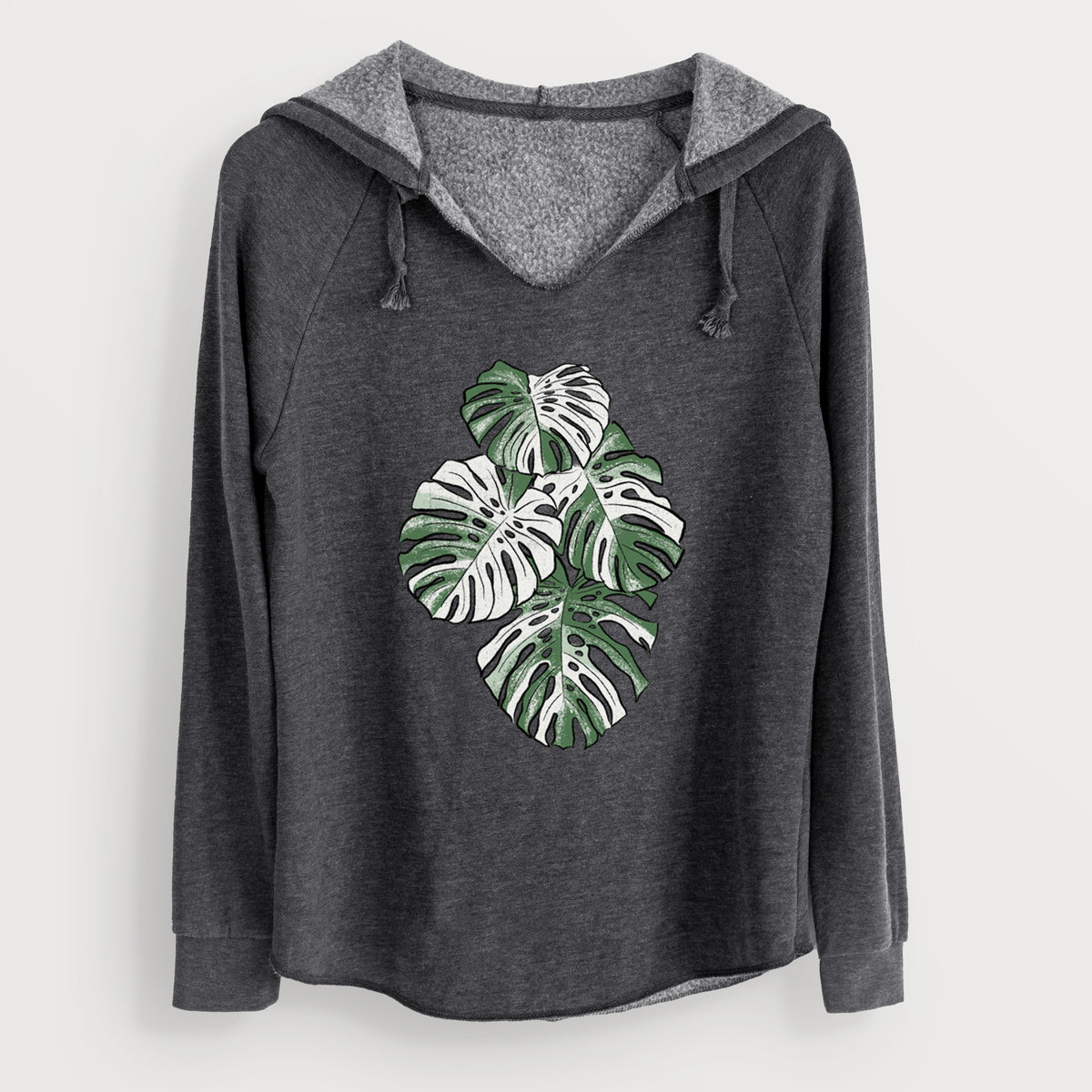 Charcoal grey women's Cali Wave hooded sweatshirt laid flat, printed with a full-color illustration of a variegated Monstera leaf in green and white.