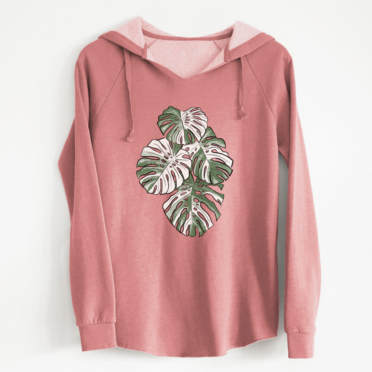 Dusty rose women's Cali Wave hooded sweatshirt laid flat, printed with a full-color illustration of a variegated Monstera leaf in green and white.