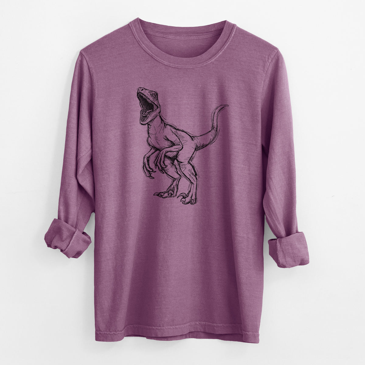 Berry pink Comfort Colors long sleeve shirt laid flat with the cuffs rolled, printed with a black ink illustration of a Velociraptor roaring.