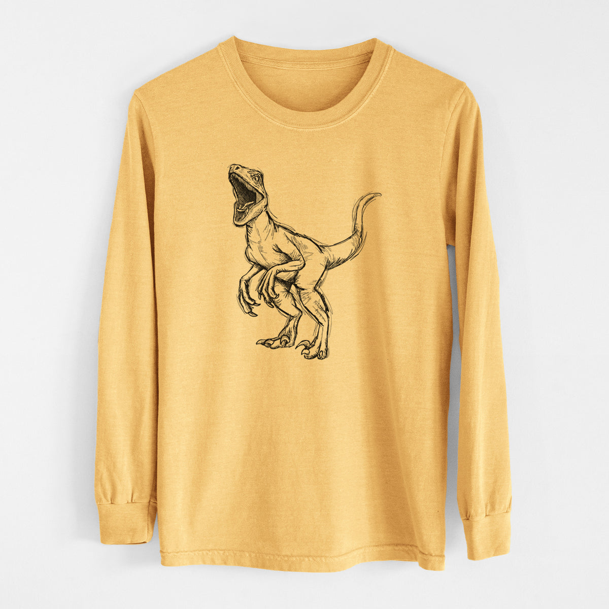Golden wheat yellow Comfort Colors long sleeve shirt laid flat, printed with a black ink illustration of a Velociraptor roaring.